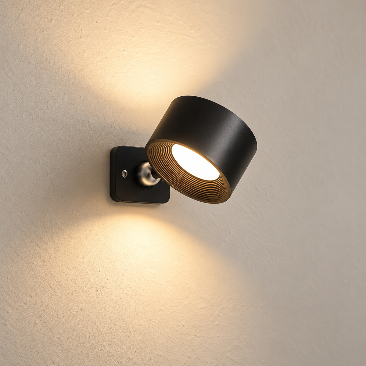 Cordless rechargeable wall lamp in matte black on a warm cream plaster wall